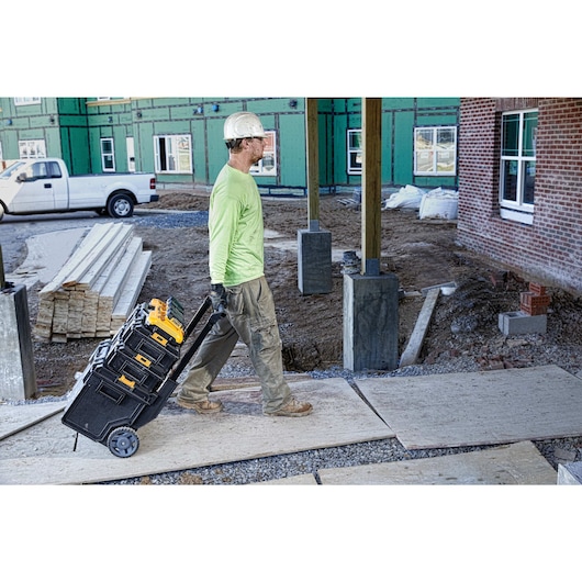 Multiport fast charger being taken to anor workspace by a construction worker Multiport fast charger being taken to anor workspace by a construction worker