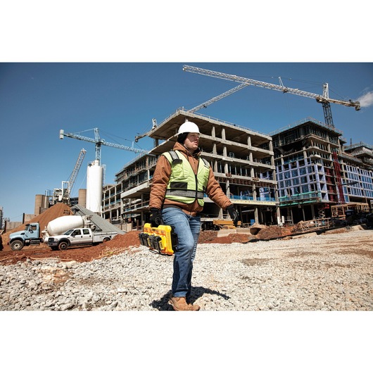 Multiport fast charger being carried by a construction worker Multiport fast charger being carried by a construction worker