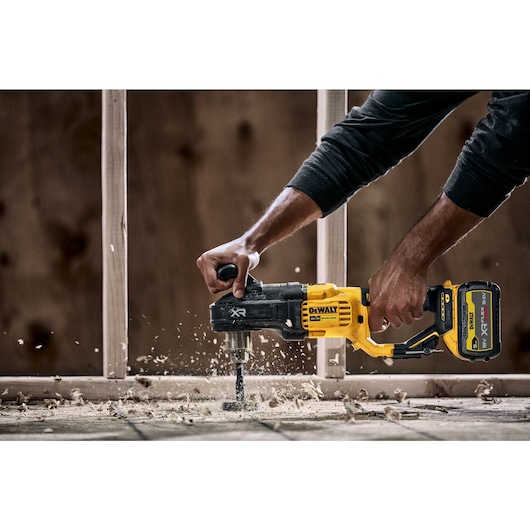 18V Brushless Compact Stud and Joist Drill drilling through floorboards