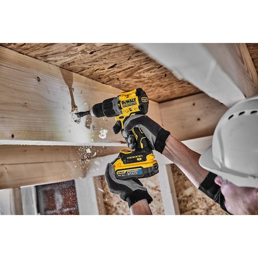 18V XR Brushless Hammer Drill Driver right side view with LED light drilling wooden beam