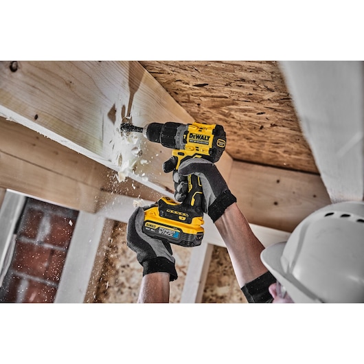 18V XR Brushless Hammer Drill Driver 3/4 right side view drilling wooden beam