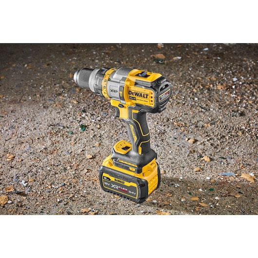 Angle view Brushless 18V XR XRP hammer drill driver with 6AH Flexvolt battery sitting on concrete floor