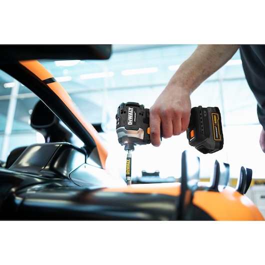 Limited Editon DEWALT/McLaren Impact Driver being used in McLaren garage on car chassis