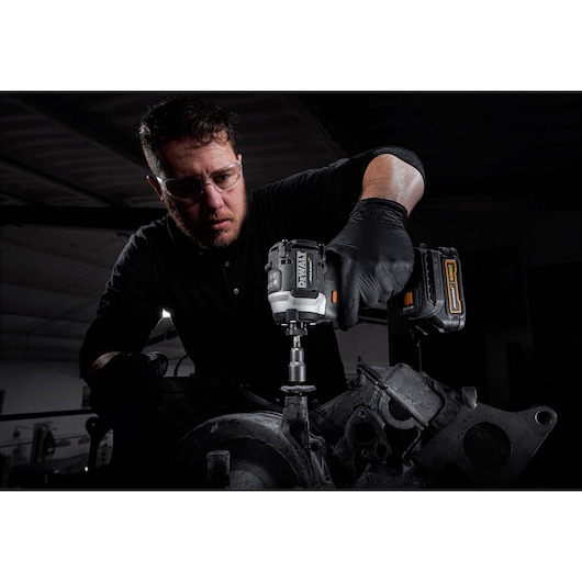 Limited Edition DEWALT/McLaren Impact Driver being used by mechanic to remove engine mounting
