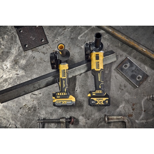 DEWALT 18V XR Brushless Compact 125mm Angle Grinder and DCG407 DEWALT 18V XR Brushless Angle Grinder on metal background