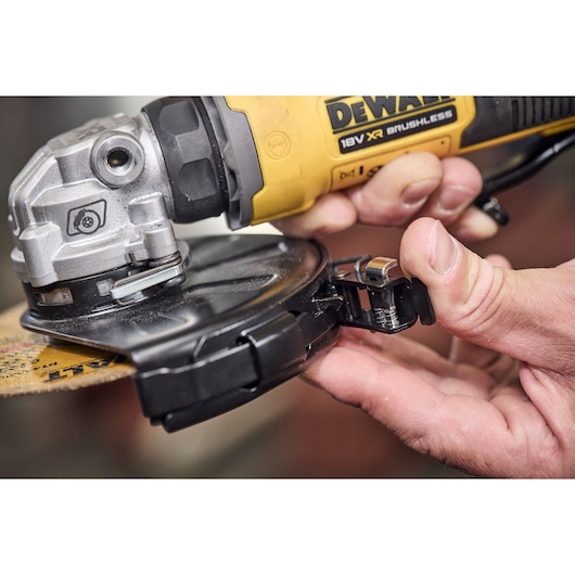 Cutting guard being attached to the DEWALT 18V XR Compact 125mm Angle Grinder