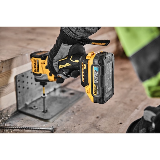 18V XR Brushless Impact Driver driving screw into a plate