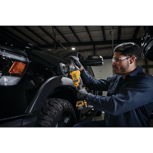 cordless variable speed random orbit polisher being used by a person to polish a car