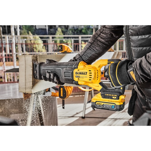 18V Brushless reciprocating saw cutting thick wood on work site
