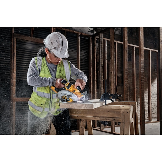 18V XR Brushless Circular Saw cutting wood on a work site