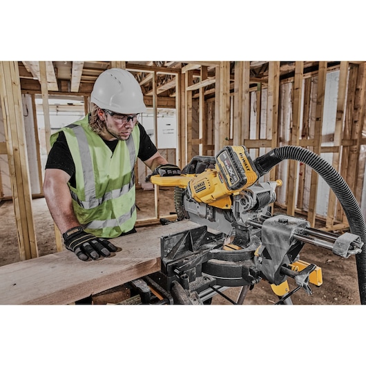 54v XR FLEXVOLT 305mm Mitre Saw 3/4 right side view used on work site 54v XR FLEXVOLT 305mm Mitre Saw 3/4 right side view used on work site