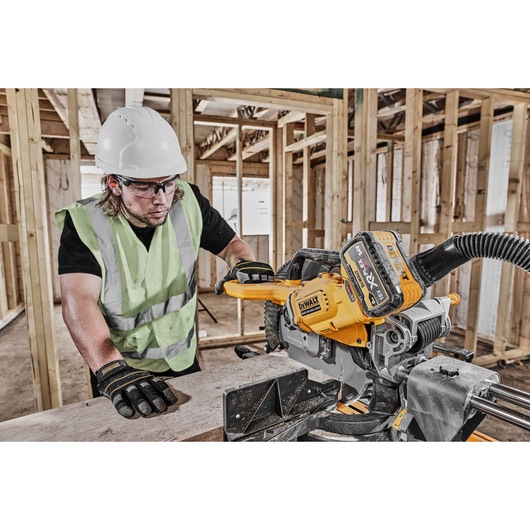 54v XR FLEXVOLT 305mm Mitre Saw 3/4 right side view used on work site 54v XR FLEXVOLT 305mm Mitre Saw 3/4 right side view used on work site