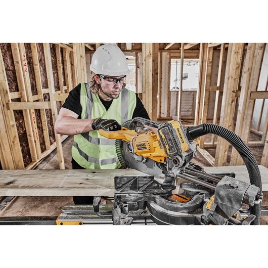 54v XR FLEXVOLT 305mm Mitre Saw 3/4 right side view used on work site 54v XR FLEXVOLT 305mm Mitre Saw 3/4 right side view used on work site