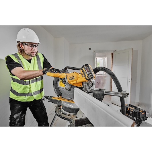 54v XR FLEXVOLT 305mm Mitre Saw right side view cutting skirting board 54v XR FLEXVOLT 305mm Mitre Saw right side view cutting skirting board