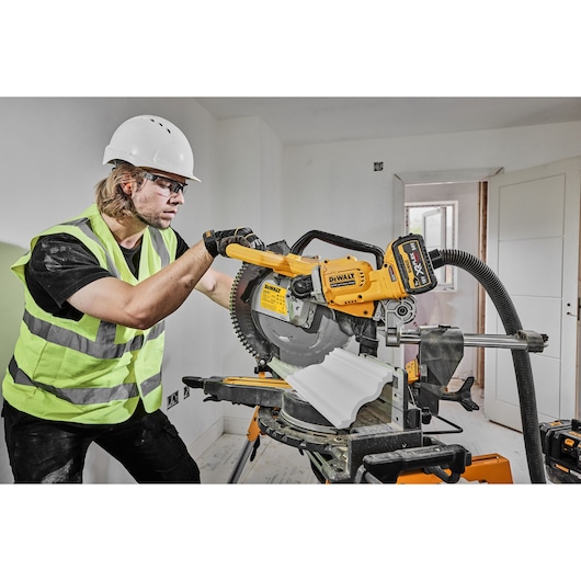 54v XR FLEXVOLT 305mm Mitre Saw right side view cutting skirting board 54v XR FLEXVOLT 305mm Mitre Saw right side view cutting skirting board