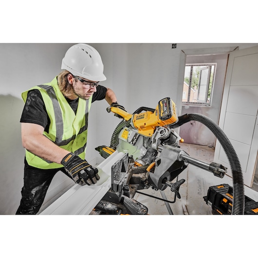 54v XR FLEXVOLT 305mm Mitre Saw 3/4 right side view cutting skirting board 54v XR FLEXVOLT 305mm Mitre Saw 3/4 right side view cutting skirting board