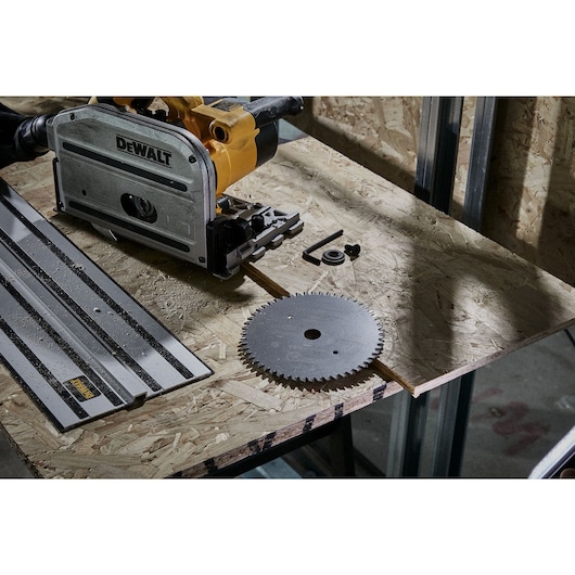 165mm circular saw blade, plunge saw and guide sitting on top of OSB