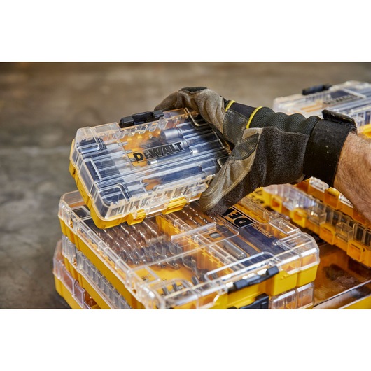 overhead front shot of user holding DEWALT 40 Piece Impact Screwdriver Bit Set with closed case lid and out the pack