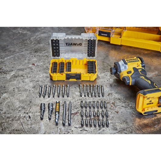 overhead shot of DEWALT 40 Piece Impact Screwdriver Bit Set with lid open, drill bits out of the box, and a DEWALT drill