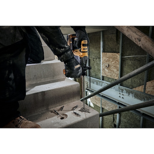 Concrete drilling using SDS Plus drill bit on the stairwell of a construction site