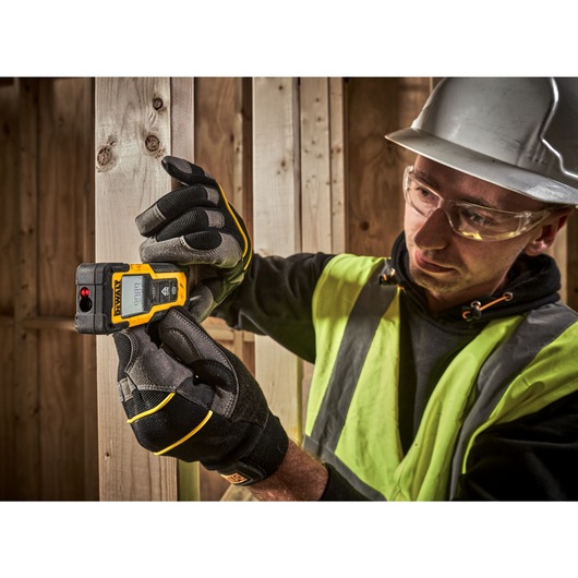 Laser and Distance Measurer in Use on a Wood Beam