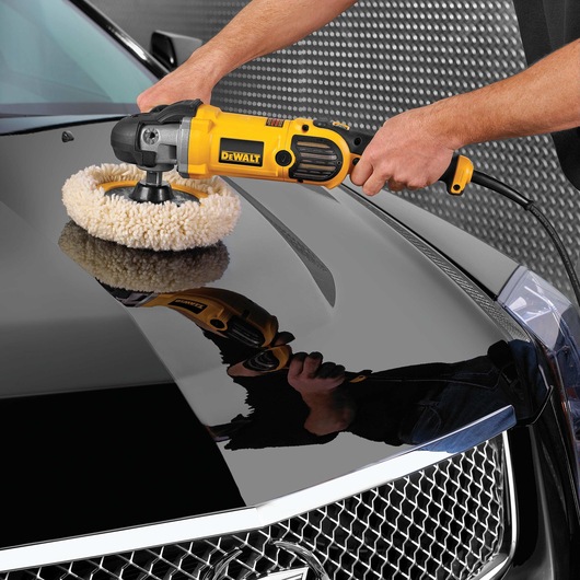 Variable speed polisher with soft start being used to polish car.