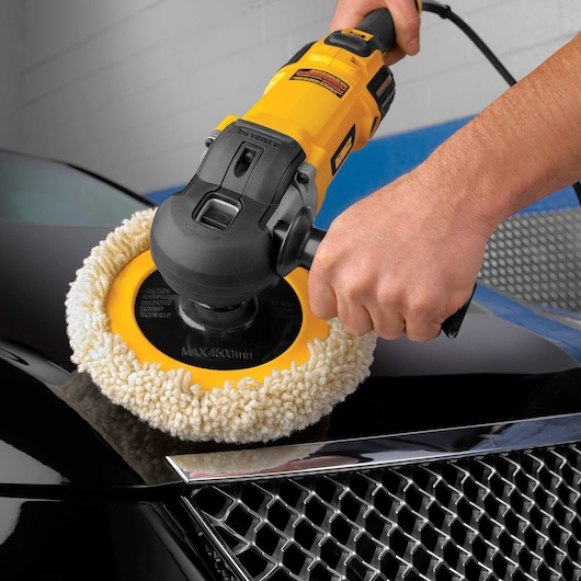 Variable speed polisher with soft start being used to polish car.