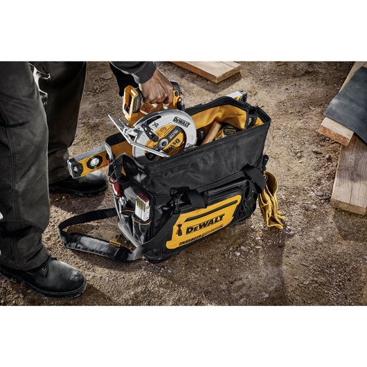 Circular saw being pulled out of the Dewalt 20" Pro Open Mouth Tool Bag" Circular saw being pulled out of the Dewalt 20" Pro Open Mouth Tool Bag"