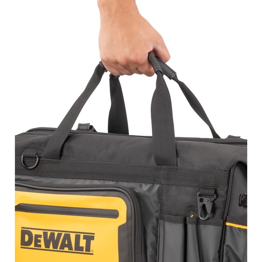 Dewalt 20" Pro Open Mouth Tool Bag being carried" Dewalt 20" Pro Open Mouth Tool Bag being carried"