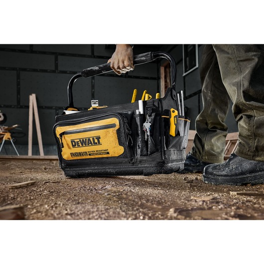 Dewalt 20" Pro Tool Tote being placed on the ground of a construction site" Dewalt 20" Pro Tool Tote being placed on the ground of a construction site"