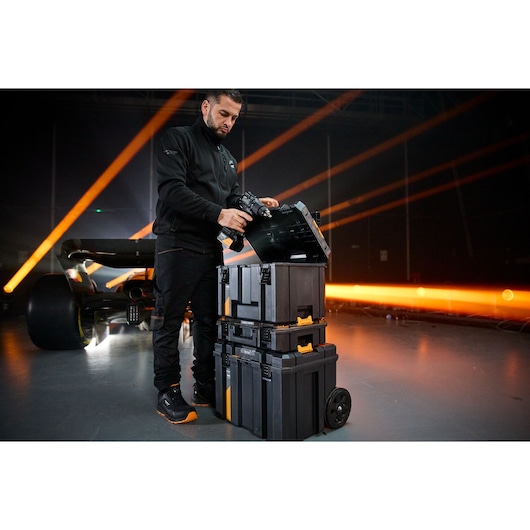 Stacked Stanley rolling toolboxes hold photography gear for secure, mobile studio use.